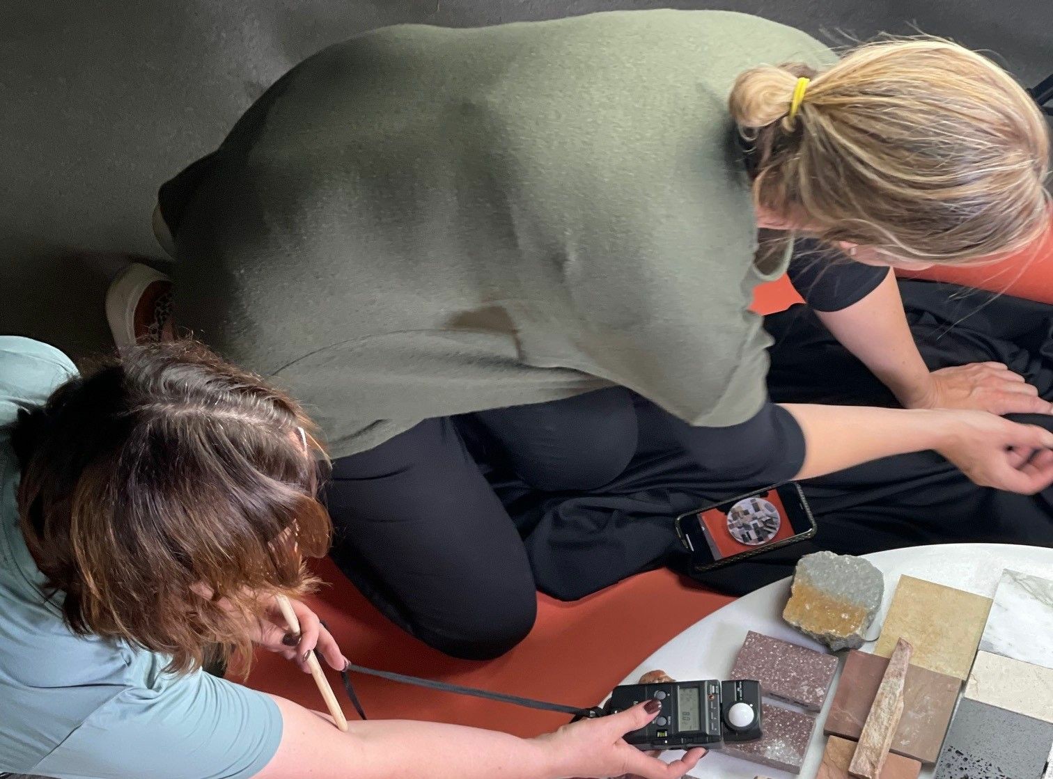 Louise and Angela working on a samples flat lay